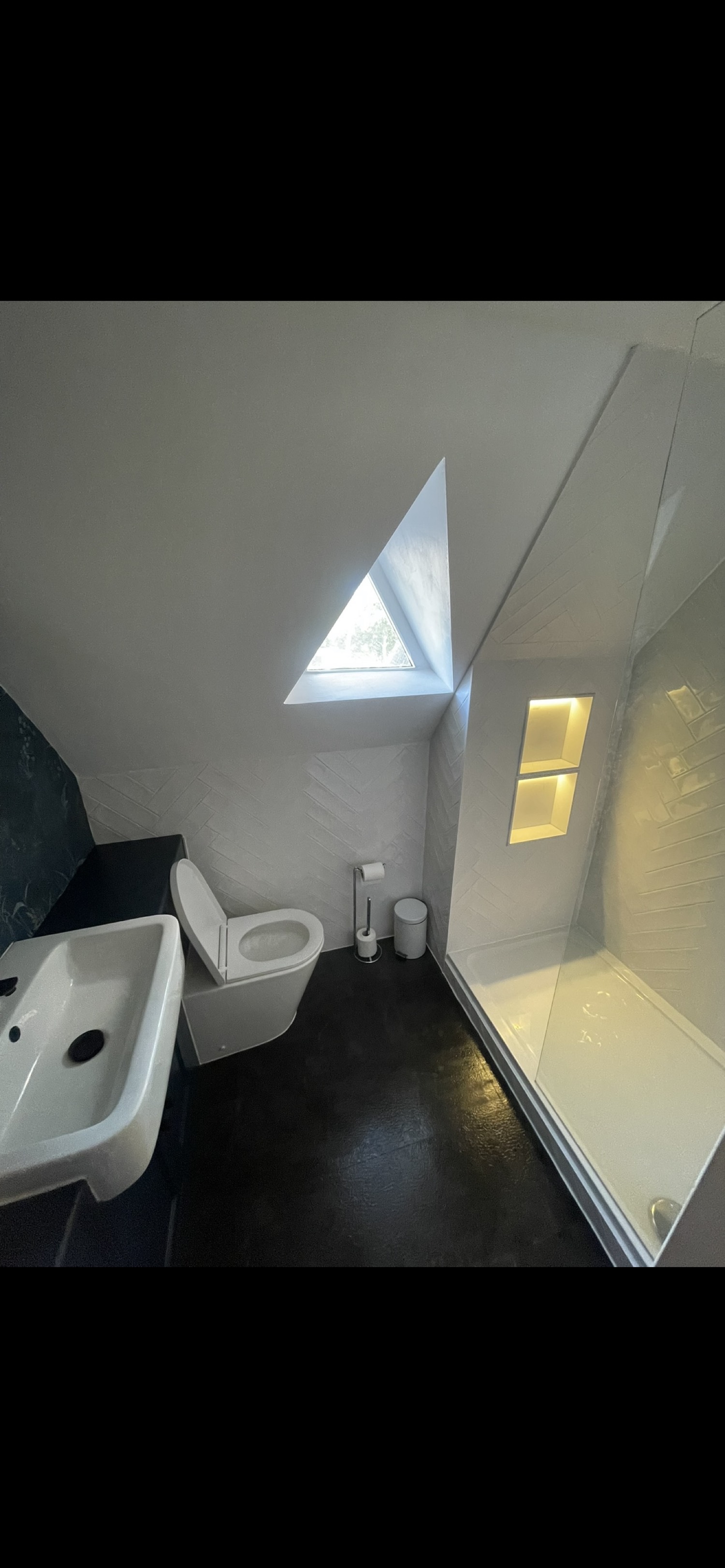 Dark bathroom with triangular window